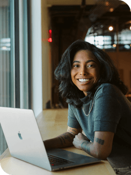 person smiling at laptop working on WP Engine Headless WordPress team