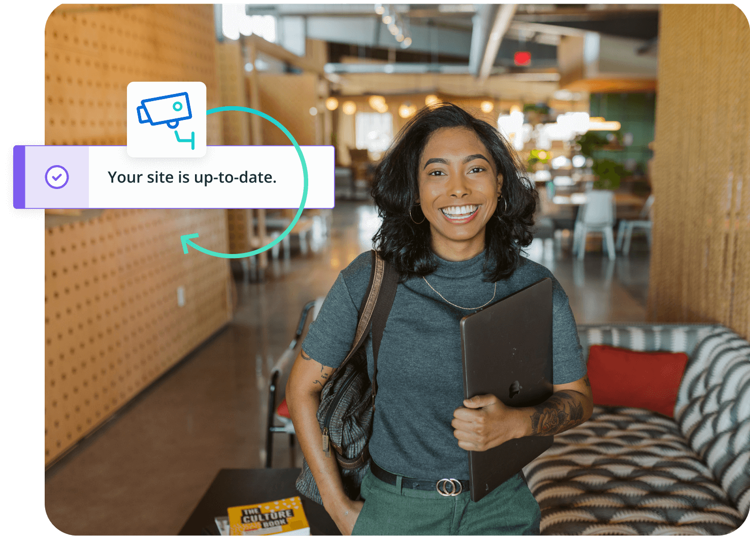 woman holding laptop in office setting