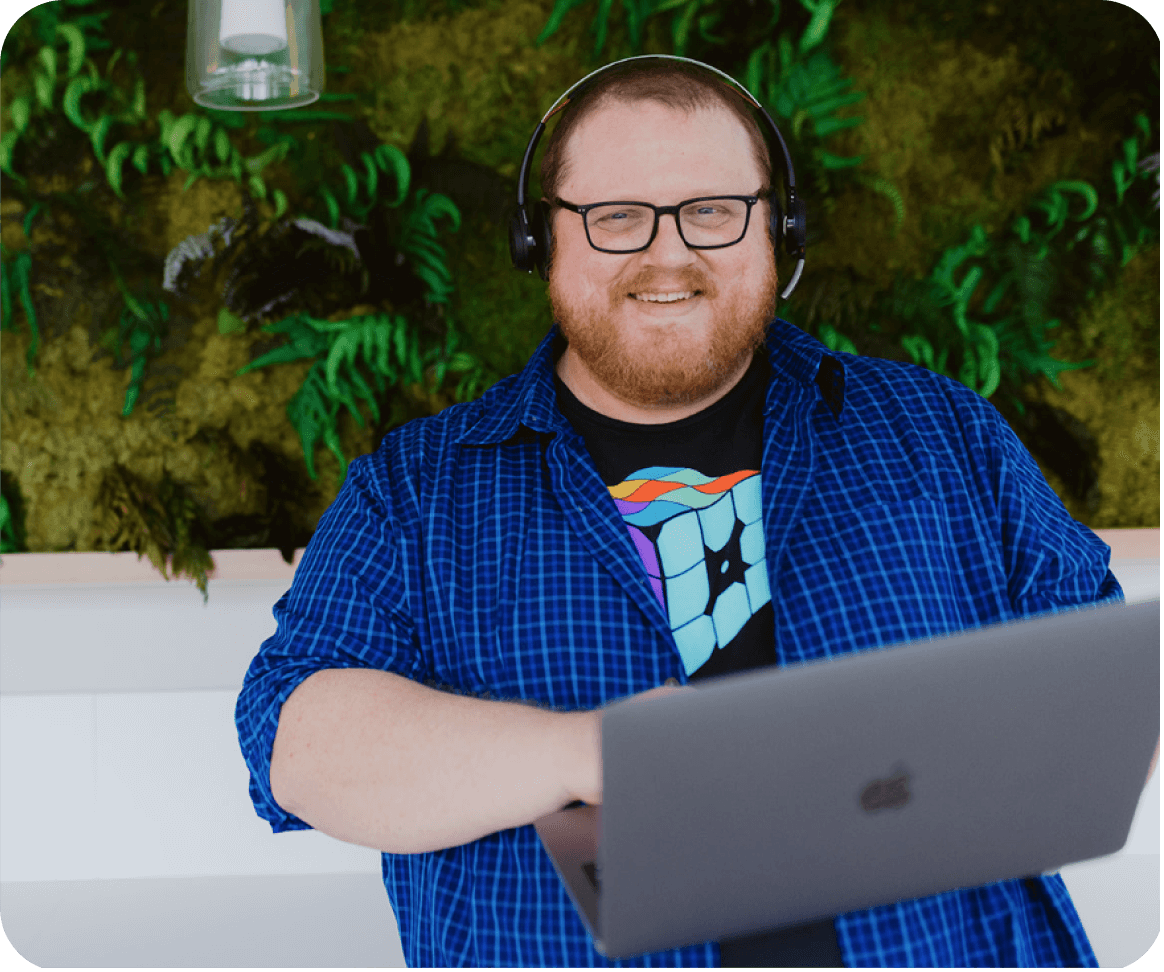 WP Engine customer support representative holding laptop and smiling