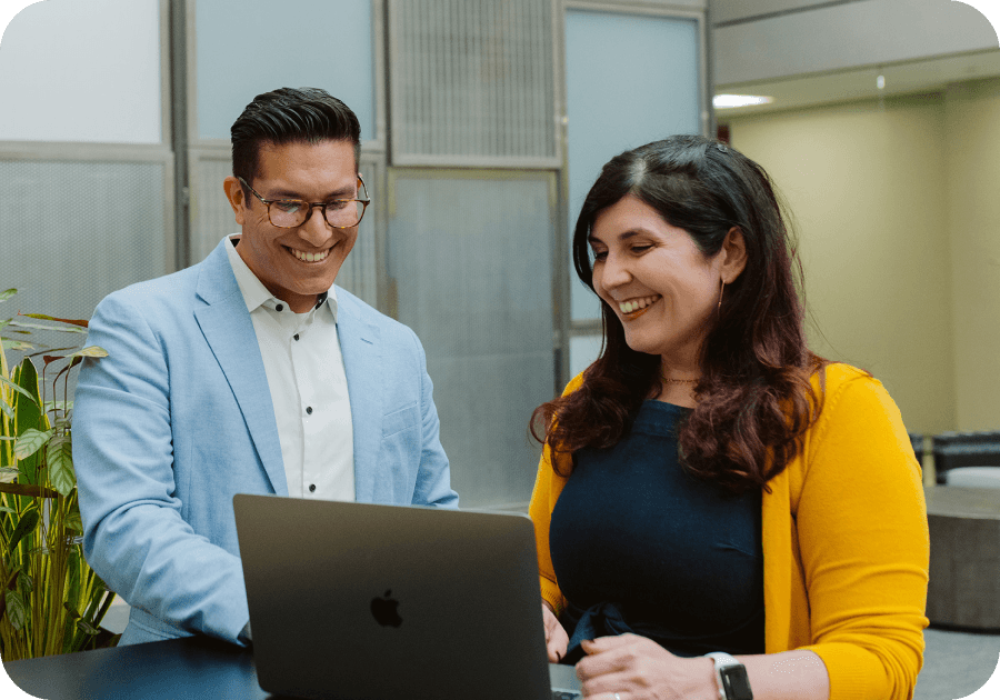 agency plans. man and woman smiling looking at laptop