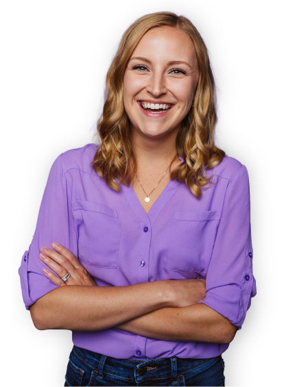 WP Engine team member wearing a purple shirt smiling with crossed arms