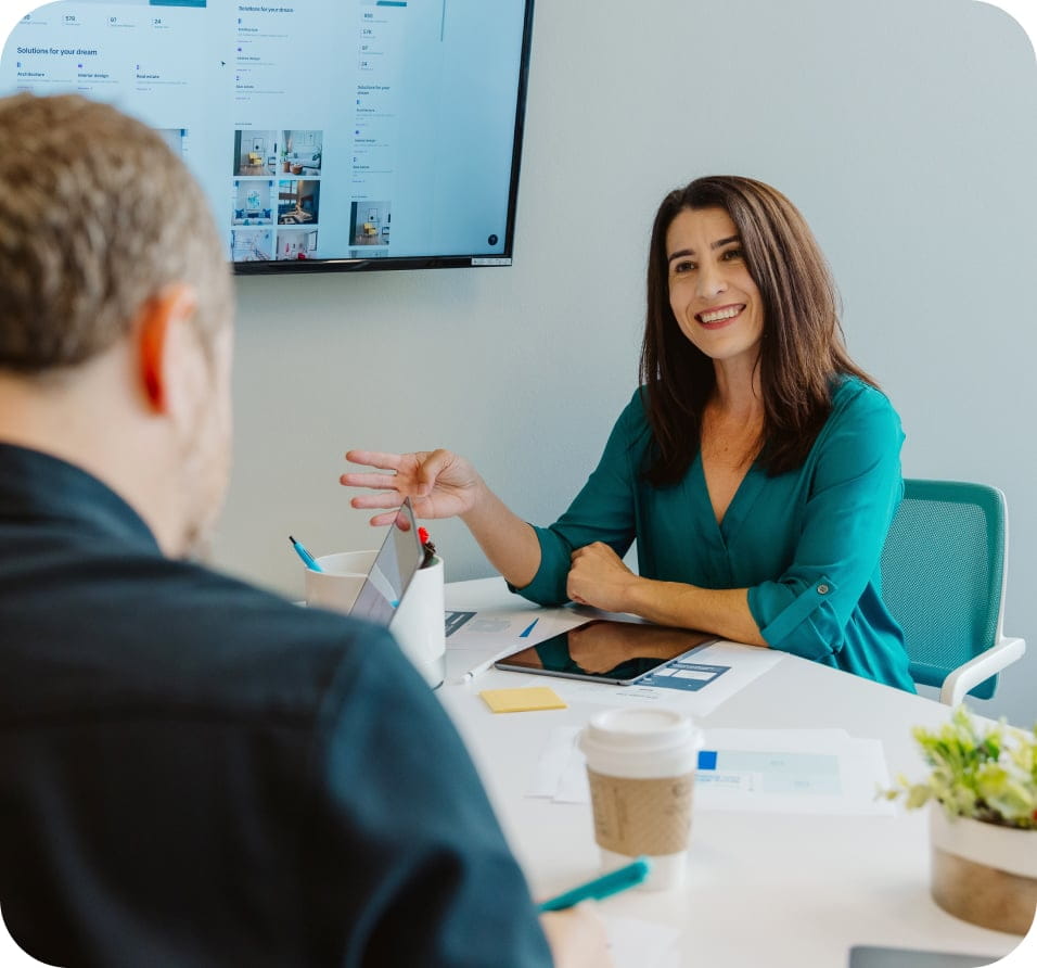 Woman in blue happily speaking to client