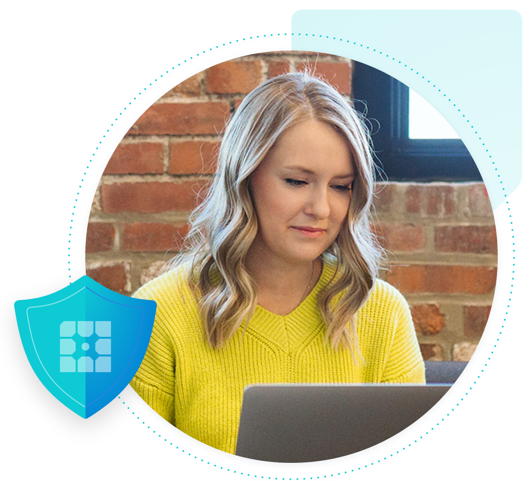 Woman in a yellow sweater looking at a laptop with a shield with WP Engine logo overlay