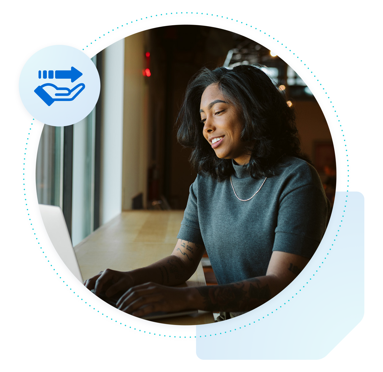 Woman at a desk smiling at a laptop with an icon indicating managed migration hovering