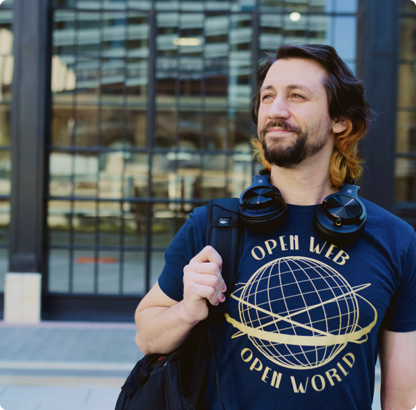 man working as Headless WordPress Developer smiling outside office building