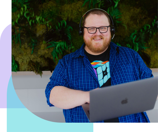 WP Engine customer support representative holding laptop and smiling