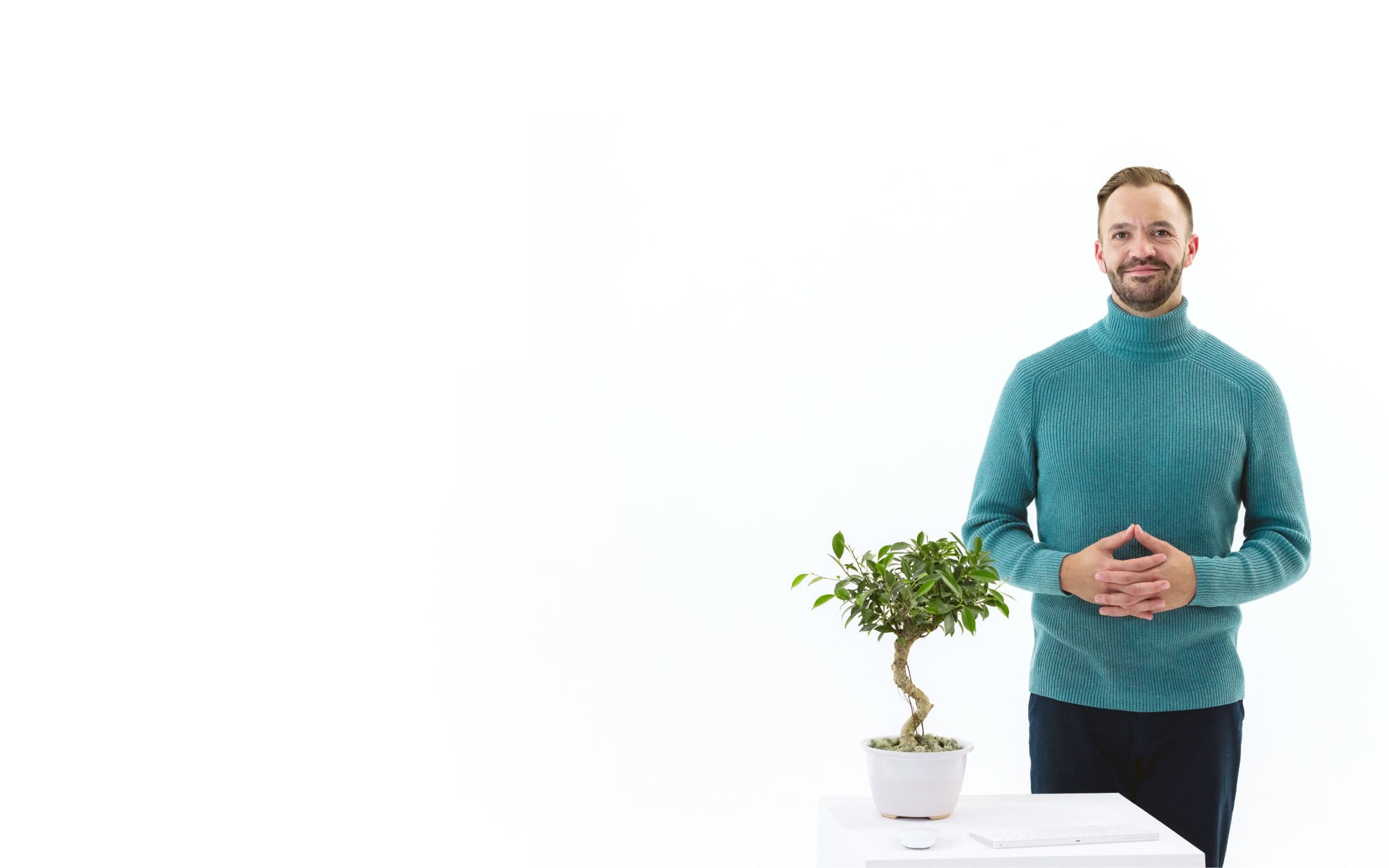 WP Engine representative looking calm with hands clasped and a bonsai tree in foreground