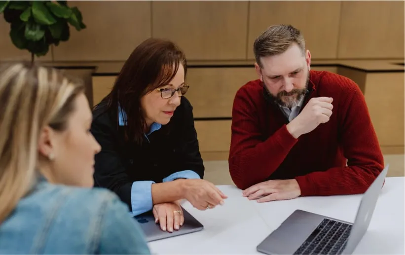 group of people looking at computer