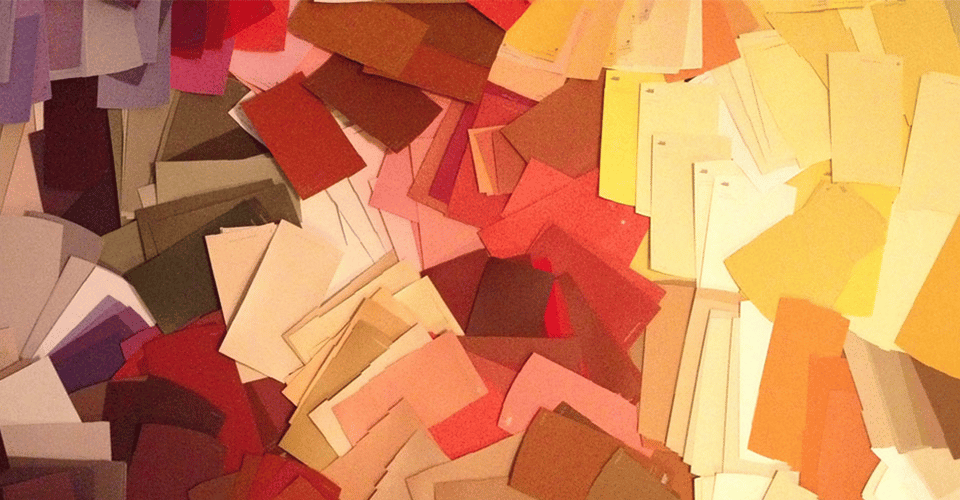 How To Control Color Opacity With RGBA in CSS. hundreds of paint swatches laid out in a messy gradient from dark purple to red to orange to yellow