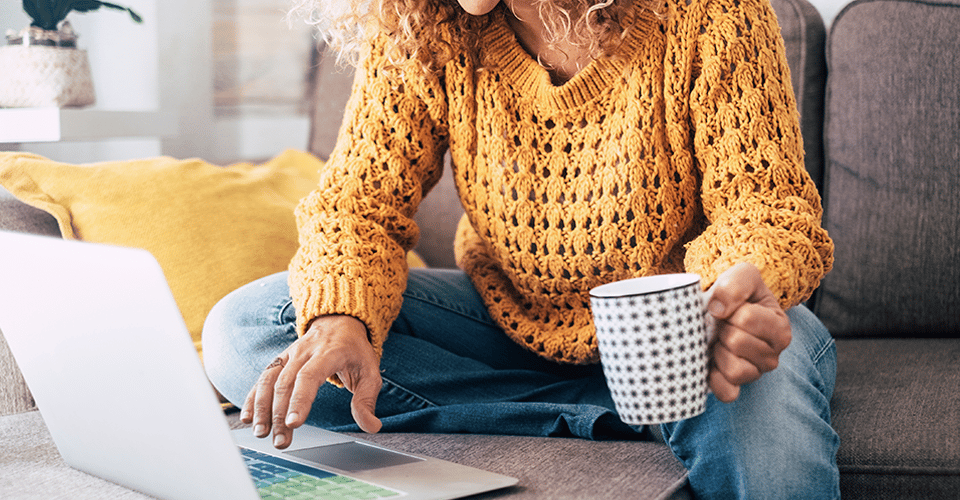 a woman in a yellow sweatshirt works on a multisite