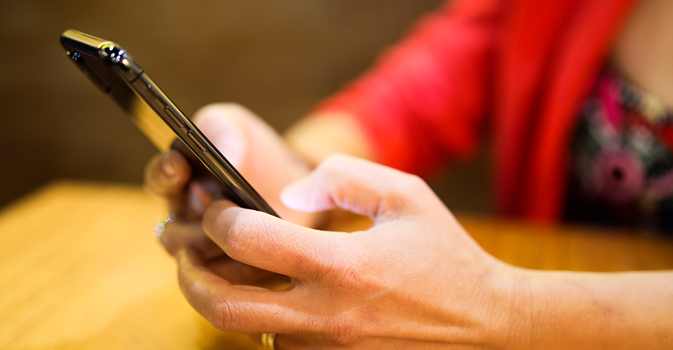 7 best practices for designing mobile navigation. Image depicts a woman using a mobile device
