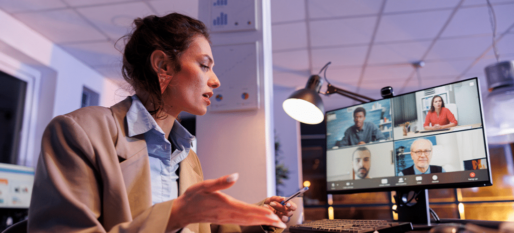 Creative professional explaining financial information to clients over Zoom call.