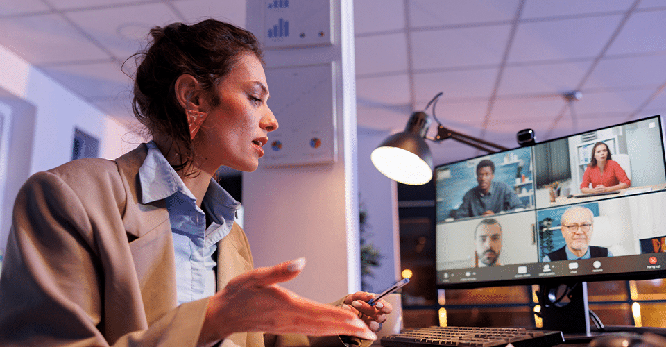Creative professional explaining financial information to clients over Zoom call.