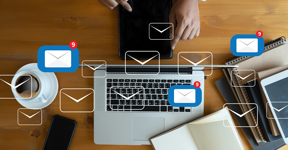Laptop with email icons and messages being sent