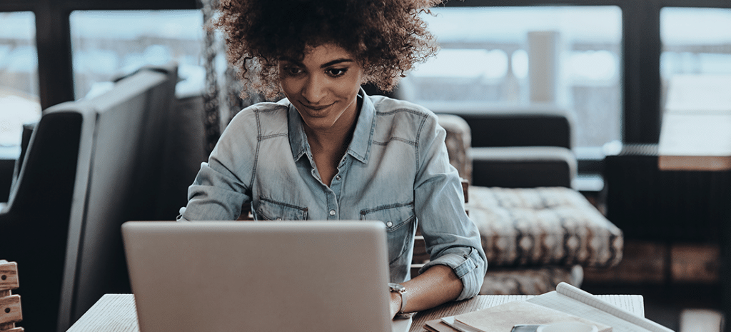 WordPress designer works at a laptop at her home desk