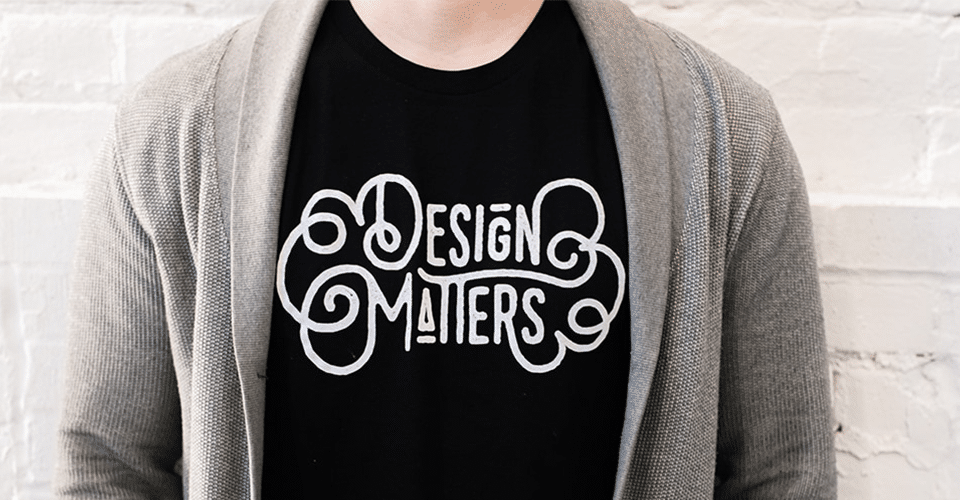 a person wears a black t-shirt displaying the phrase Design Matters