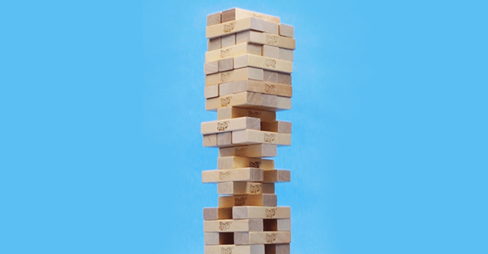 Jenga tower on blue background