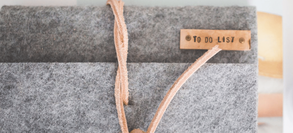 gray felt-bound notebook with a brown tag that reads To Do List