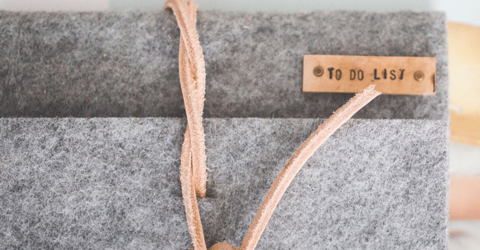 gray felt-bound notebook with a brown tag that reads To Do List