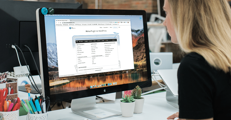 a woman studies a mega menu structure on a laptop