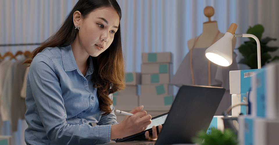 WordPress for eCommerce, image depicts a woman double checking an eCommerce order placed on her website