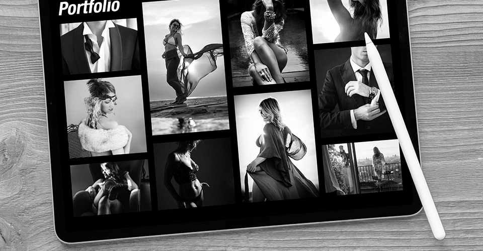 black and white overhead shot of a portfolio website open on a tablet which sits on a wooden surface