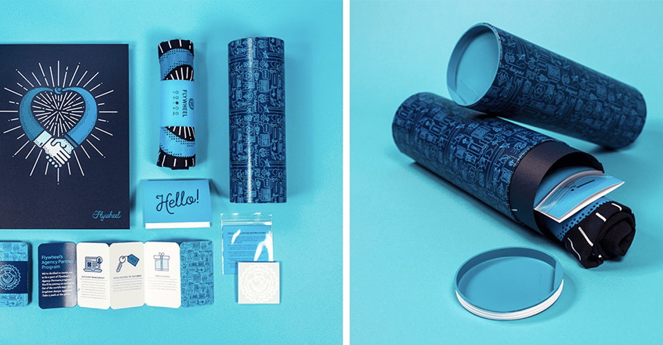 product photography for branded products. On the right, you see different brochures laid out beautifully. To the left, you see a rolled up T-shirt in a branded cylindrical container