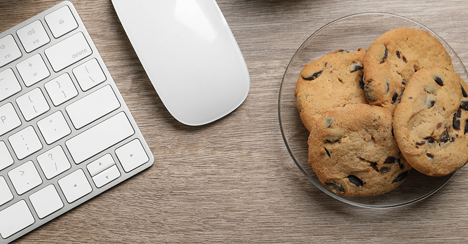 a plate of cookies next to a computer. WordPress cookies