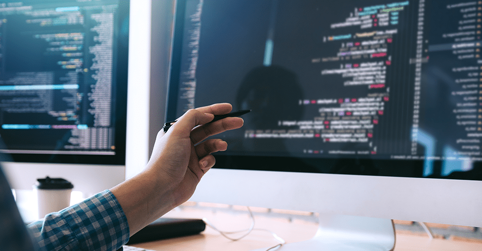 How To Use Ajax in WordPress. a person checks their code on a Mac desktop