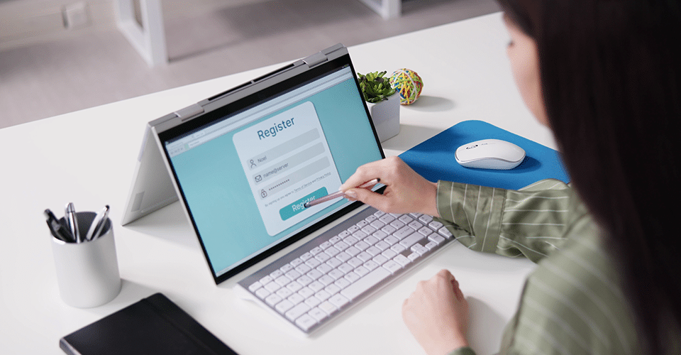 WordPress User Registration Plugins. Image shows a woman filling out a user registration form on a tablet.