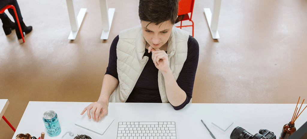 a person working at a desk seriously considers their relationship with a client