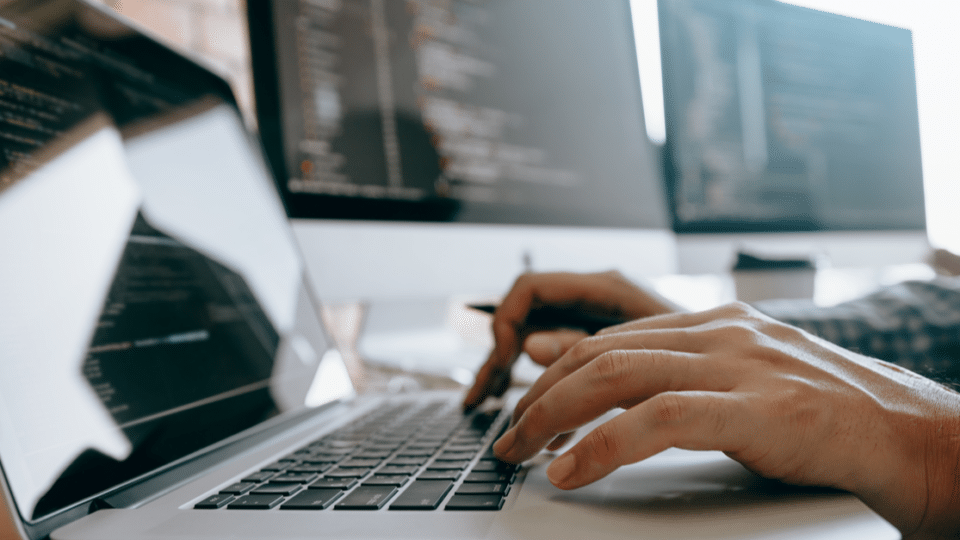 How to Use jQuery in WordPress. image depicts a person working on a WordPress site