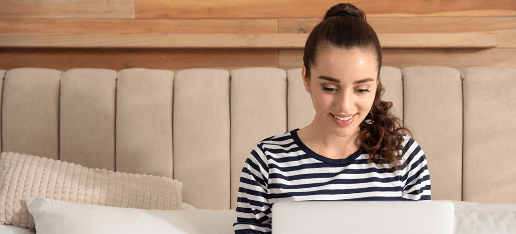 a woman in a striped sweater works on a design
