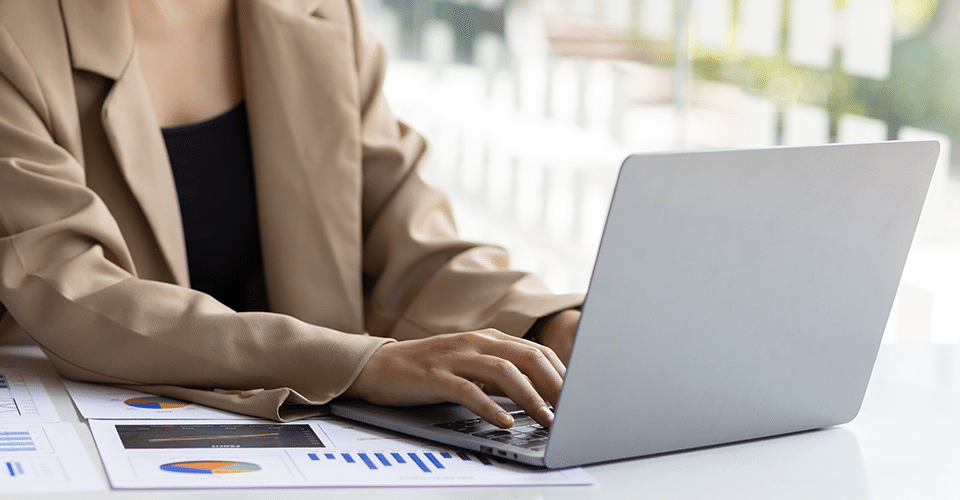 a professional types on a laptop