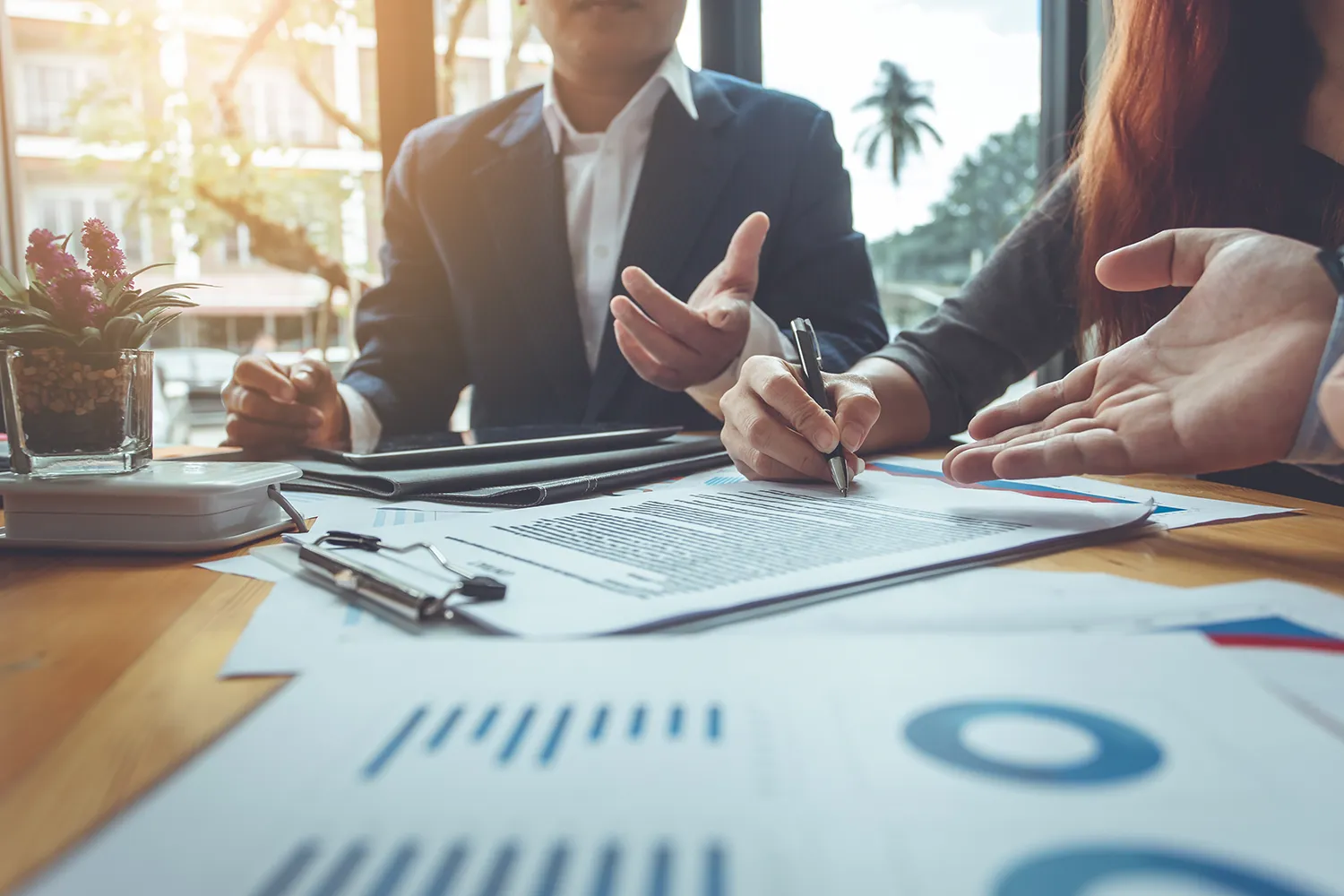 People sitting with their lawyer signing a contract