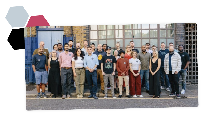 An image of the Fat Beehive team from their website with some of their brand elements behind it.