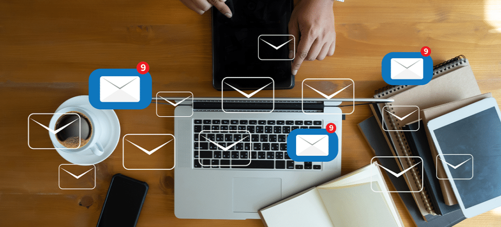 Laptop with email icons and messages being sent