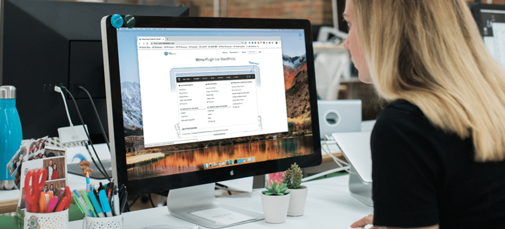 a woman studies a mega menu structure on a laptop