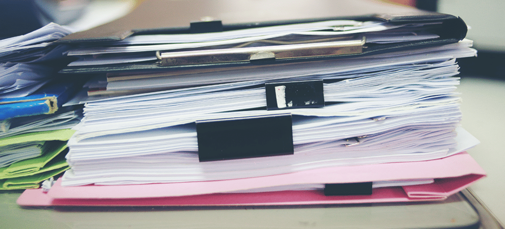 a stack of contracts on a desk