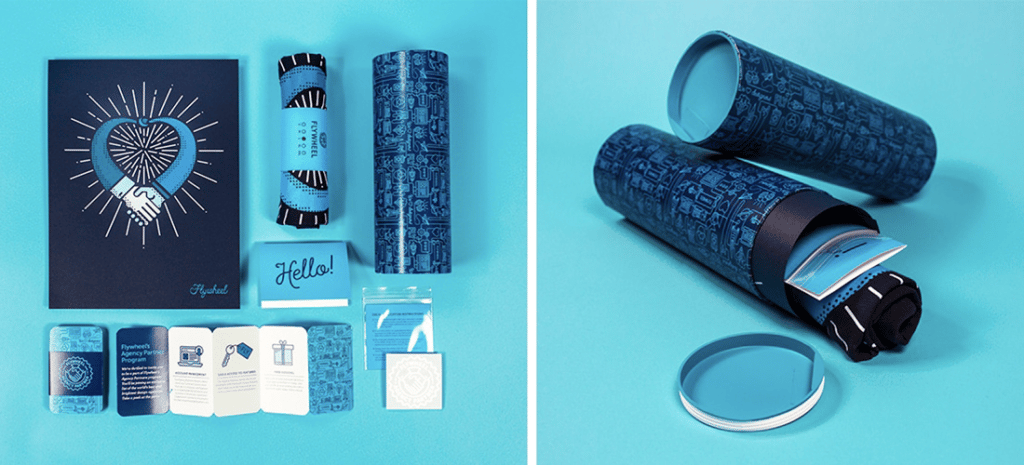 product photography for branded products. On the right, you see different brochures laid out beautifully. To the left, you see a rolled up T-shirt in a branded cylindrical container