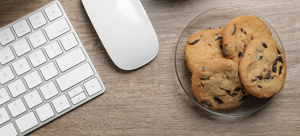 a plate of cookies next to a computer. WordPress cookies
