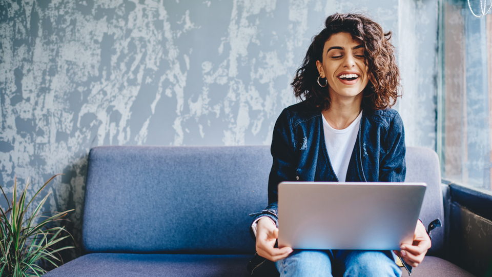 Happy stylish female blogger laughing