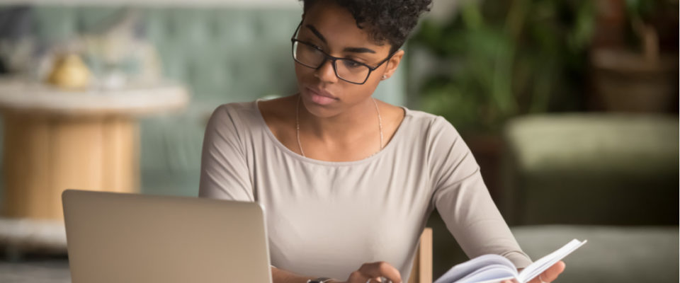 Photo of woman looking at laptop and taking notes about WordPress heatmap use