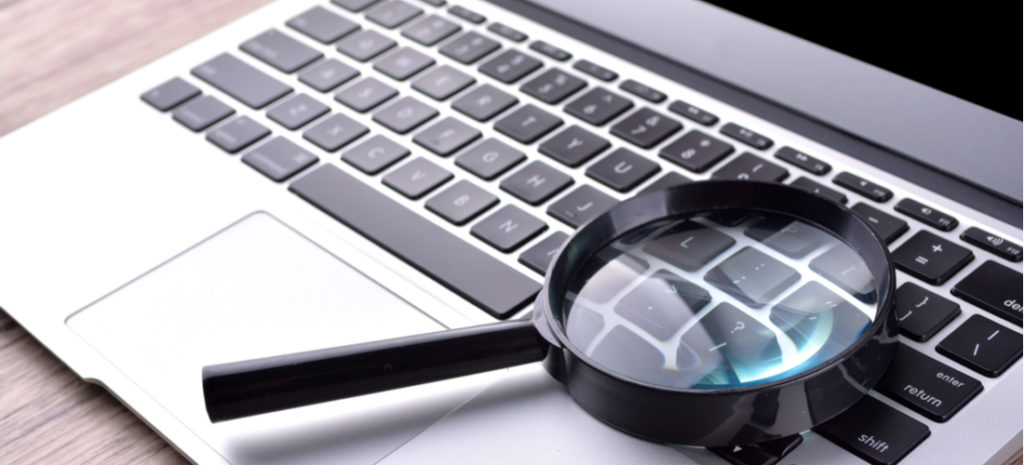 Image of a magnifying glass on a MacBook laptop