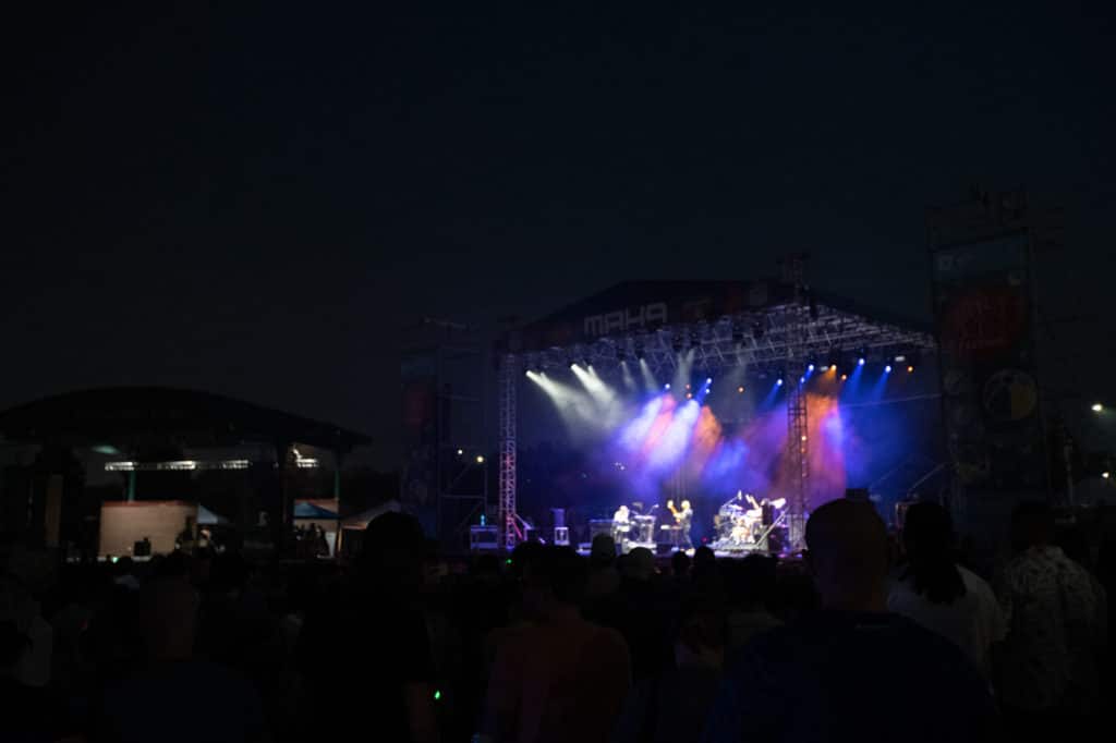 An audience member's view of the main stage at night during Maha Music Festival