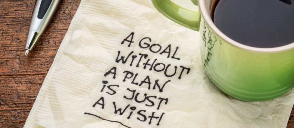 Napkin with a note reading "a goal without a plan is just a wish"