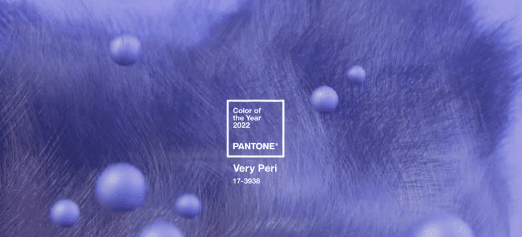 promotional image in Pantone shade Very Peri. The background has a fuzzy texture and small spheres float in the foreground