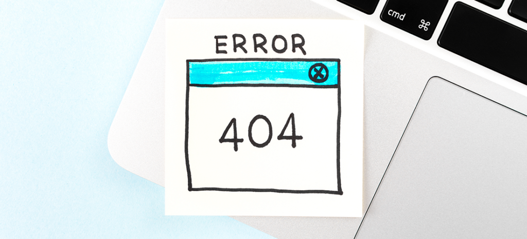 How to set up redirects in WordPress. Image depicts the corner of a laptop. There is a sticky note on it that reads Error 404