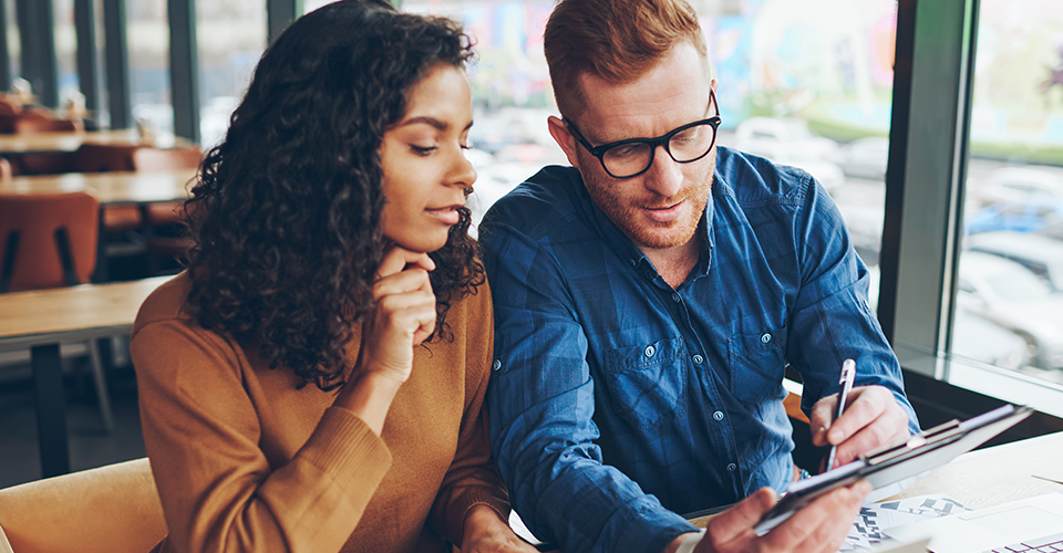 two people check personalized website experiences on a laptop and tablet