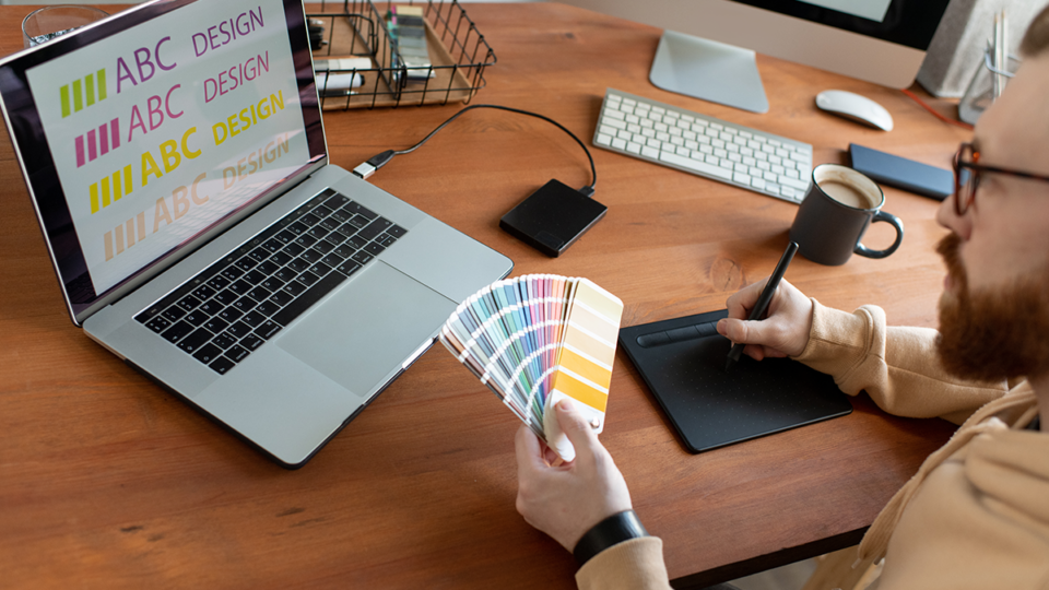 a designer tests a serif font with a swatch of brand colors